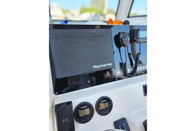 Slide: The Image of 2023 Tidewater boat dashboard featuring Raymarine electronics and Yamaha gauges. - 2
