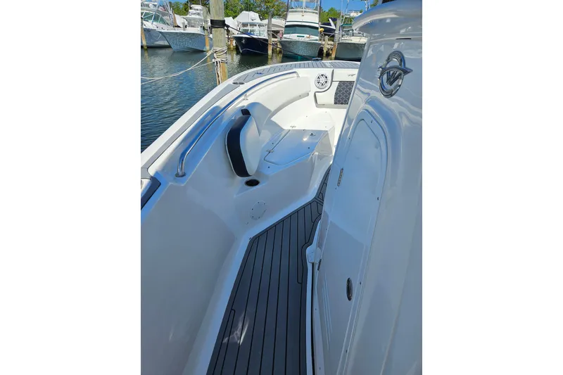 Slide: The Image of 2023 Tidewater boat interior with sleek seating and modern design at a marina. - 5