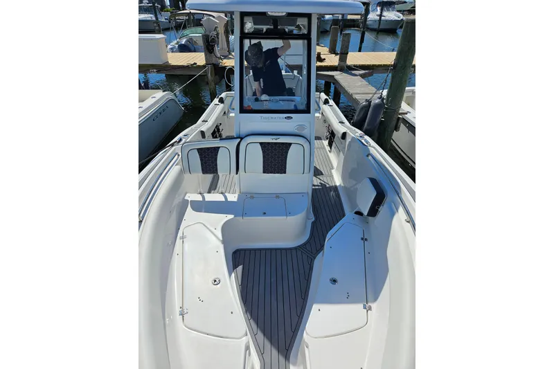 Slide: The Image of 2023 Tidewater boat interior with seating and console at marina. - 9