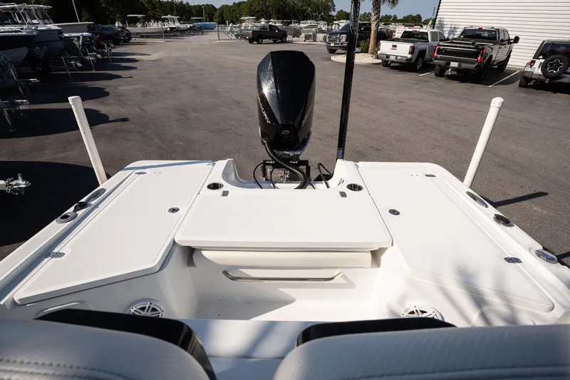 Slide: The Image of 2022 Wellcraft 241 Bay boat's rear deck and motor in a marina setting. - 14