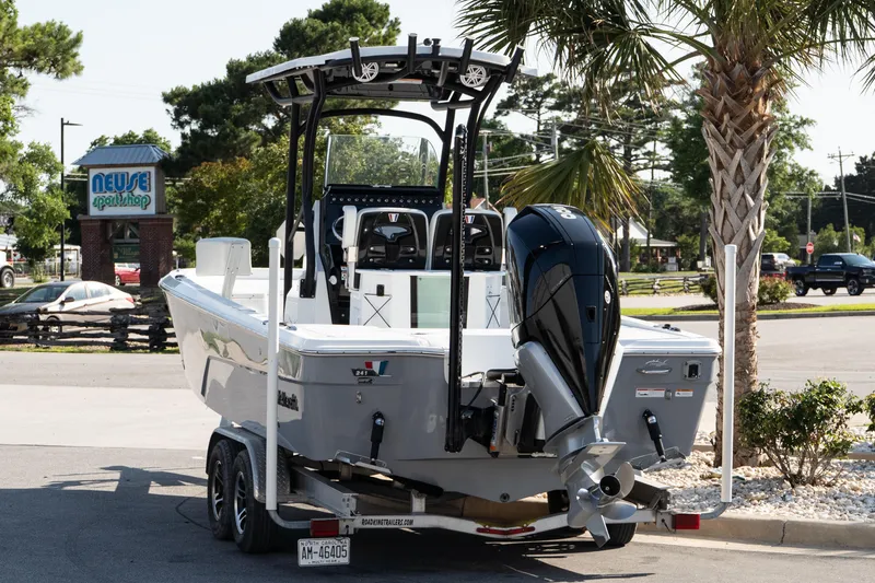 Slide: The Image of 2022 Wellcraft 241 Bay boat on trailer, parked near Neuse Sport Shop. - 4