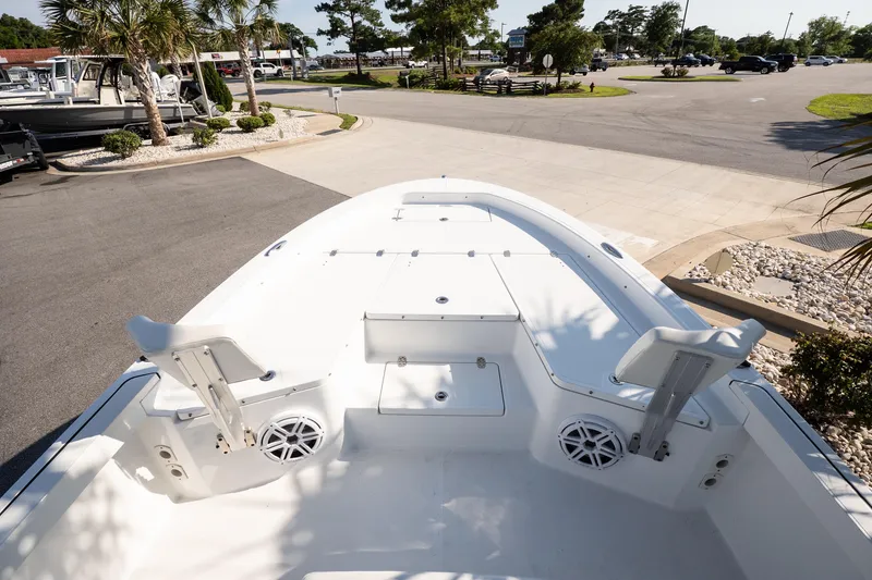Slide: The Image of 2022 Wellcraft 241 Bay boat deck with seating and speakers, parked outdoors. - 9