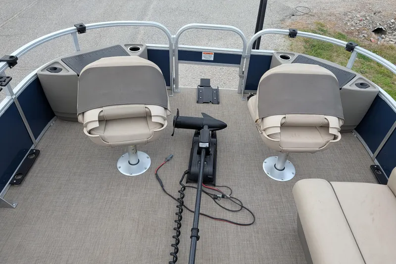 Slide: The Image of 2023 Sun Tracker Fishin' Barge 20 DLX interior with swivel seats and fishing equipment. - 38