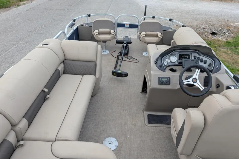 Slide: The Image of 2023 Sun Tracker Fishin' Barge 20 DLX interior with beige seating and steering console. - 44