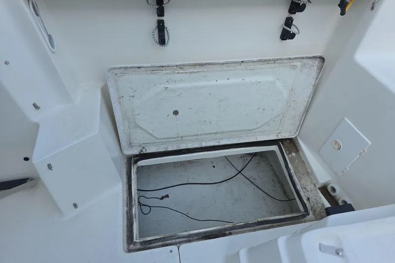 Slide: The Image of Open storage compartment on a 1999 Bayliner 2452 Ciera Express boat deck. - 11