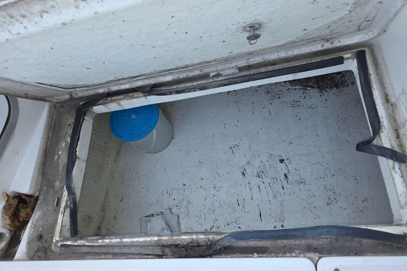 Slide: The Image of Open storage compartment on a 1999 Bayliner 2452 Ciera Express boat. - 12