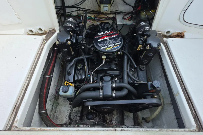 Slide: The Image of Engine compartment of a 1999 Bayliner 2452 Ciera Express boat, featuring a MerCruiser engine. - 16