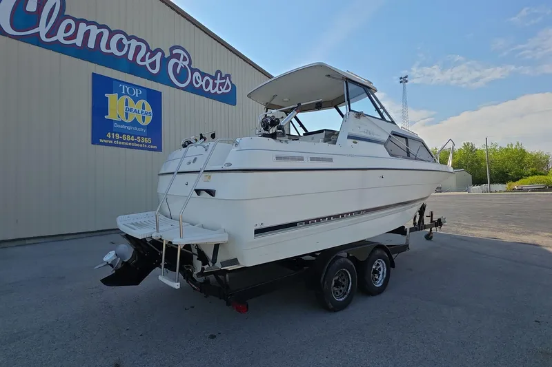 Slide: The Image of 1999 Bayliner 2452 Ciera Express boat on trailer at Clemons Boats dealership. - 2