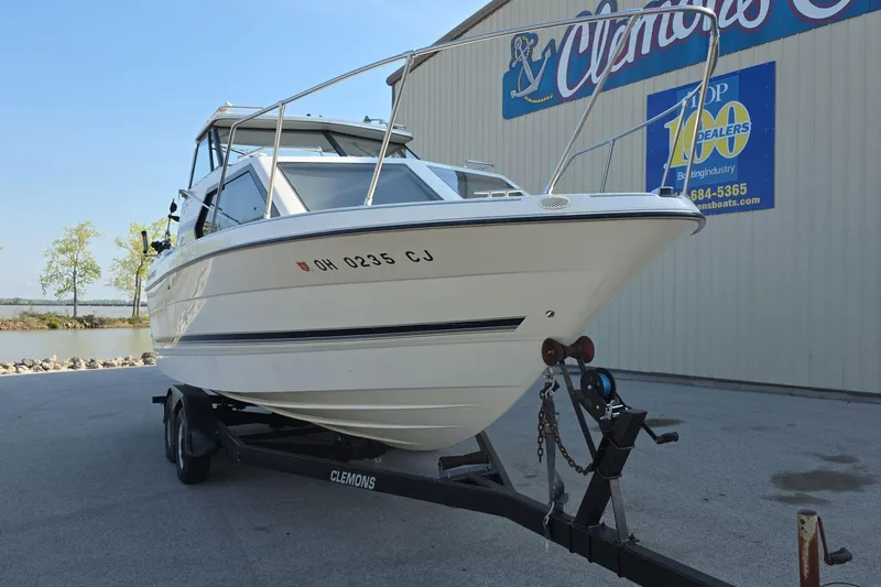 Slide: The Image of 1999 Bayliner 2452 Ciera Express boat on trailer near dealership. - 3