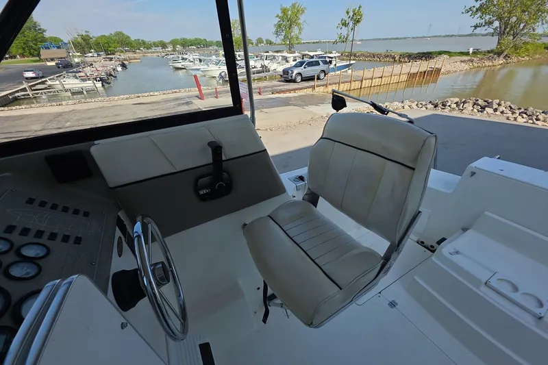 Slide: The Image of Interior view of a 1999 Bayliner 2452 Ciera Express boat at a marina. - 5