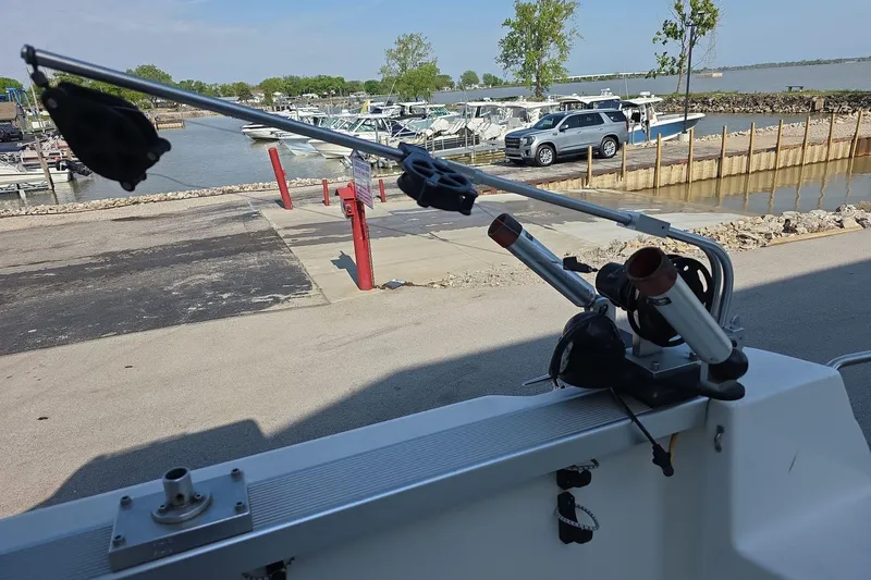 Slide: The Image of 1999 Bayliner 2452 Ciera Express at marina with fishing rod holders. - 8