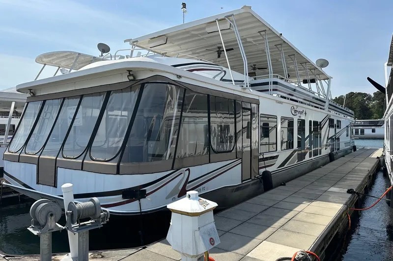 The Image of 2004 Sumerset 18x96 houseboat docked at marina, featuring spacious upper deck. - 0