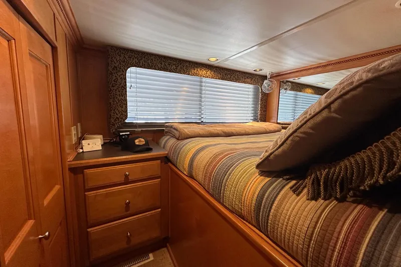 Slide: The Image of Luxurious bedroom interior of 2004 Sumerset 18x96 houseboat with striped bedding and wooden cabinetry. - 10