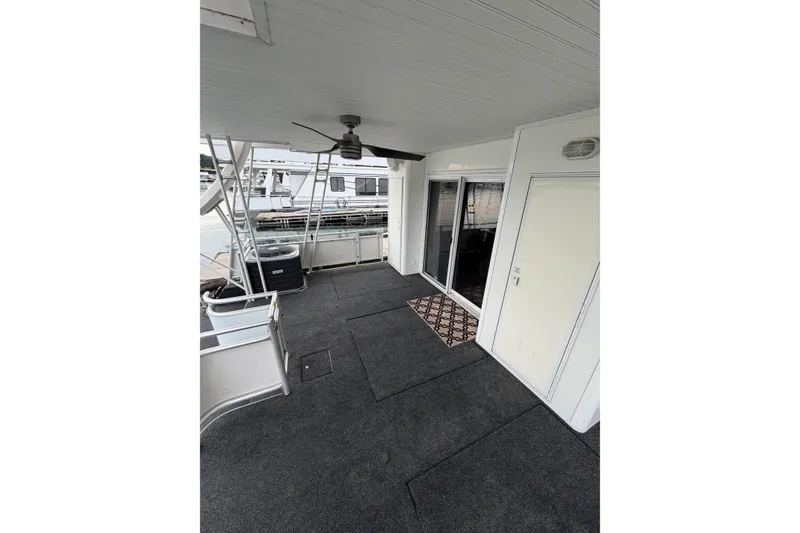 Slide: The Image of 2004 Sumerset 18x96 houseboat deck with ceiling fan and sliding glass doors. - 13