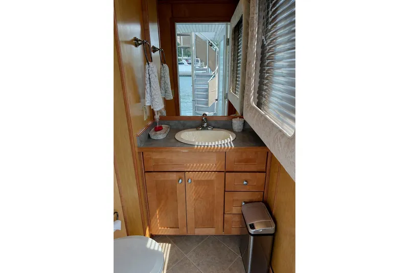 Slide: The Image of Bathroom interior of 2004 Sumerset 18x96 houseboat with wooden cabinetry and modern fixtures. - 14