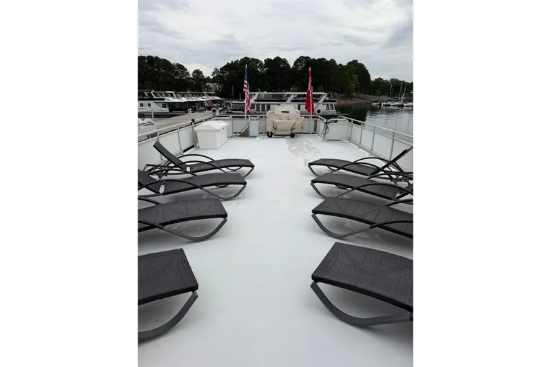 Slide: The Image of Spacious deck of 2004 Sumerset 18x96 houseboat with lounge chairs and scenic marina view. - 18
