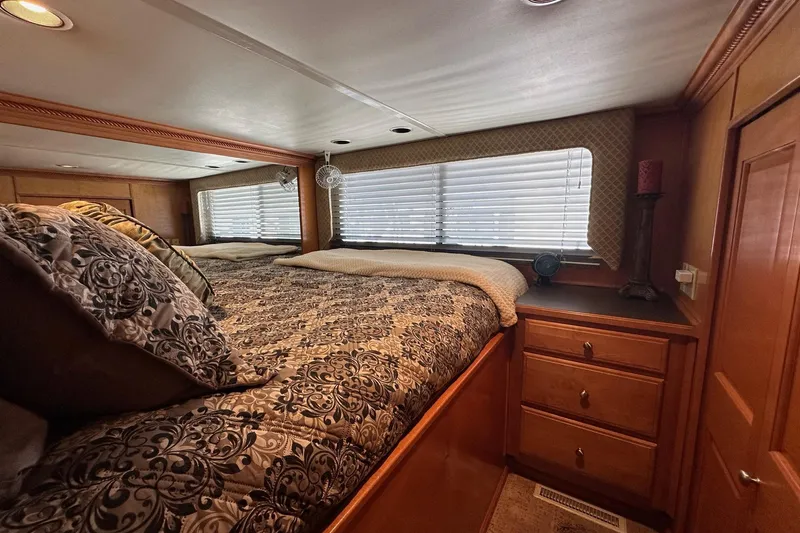 Slide: The Image of Luxurious bedroom interior in a 2004 Sumerset 18x96 houseboat with elegant bedding and wood cabinetry. - 7