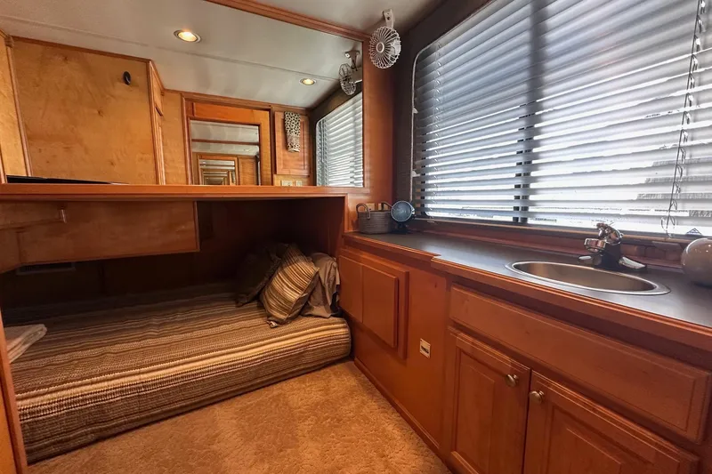 Slide: The Image of Cozy bedroom with wood cabinetry and sink in 2004 Sumerset 18x96 houseboat. - 8