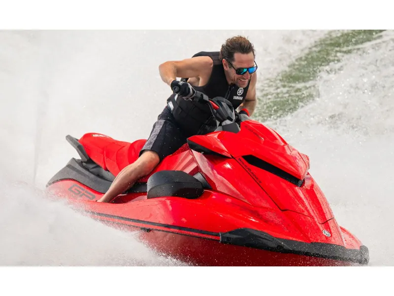 Slide: The Image of Man riding 2026 Yamaha GP SVHO jet ski in red design. - 7