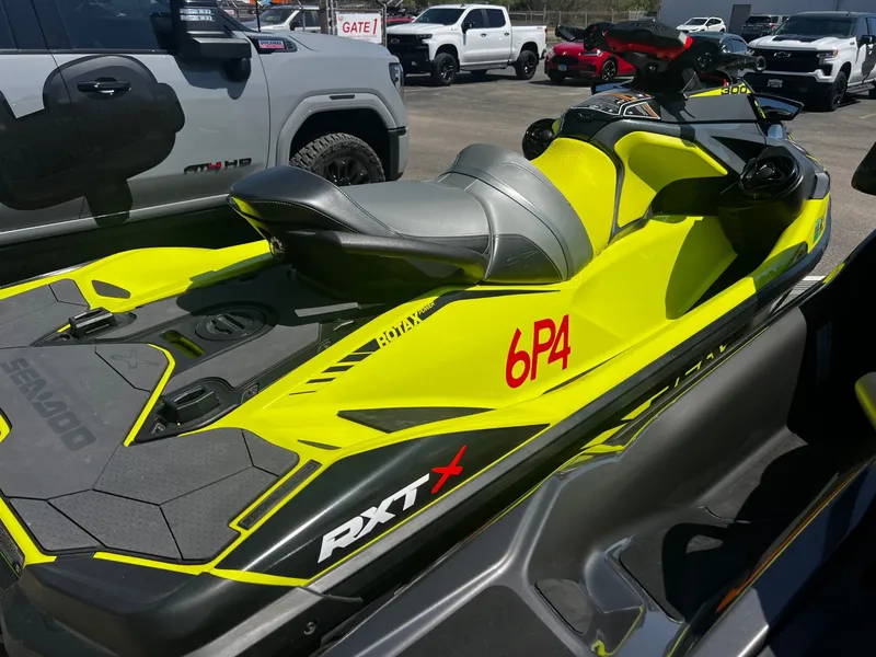 Slide: The Image of 2019 Sea-Doo RXT-X 300 iBR with sound system, yellow, parked. - 3