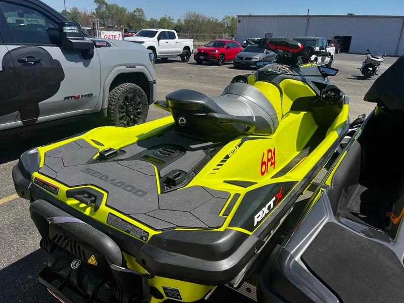 Slide: The Image of 2019 Sea-Doo RXT-X 300 iBR jet ski in parking lot. - 4