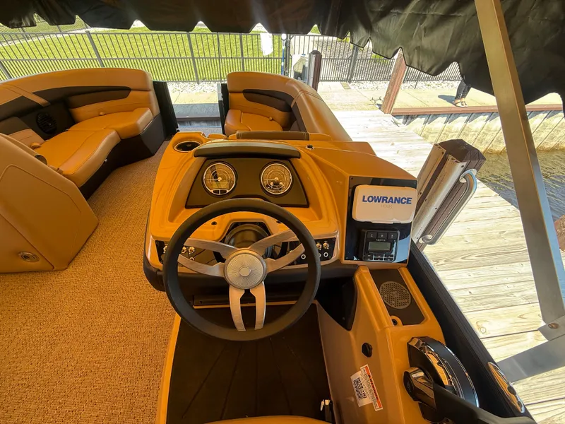Slide: The Image of Interior of 2024 Barletta CABRIO 24 UETT with steering wheel and Lowrance system. - 9