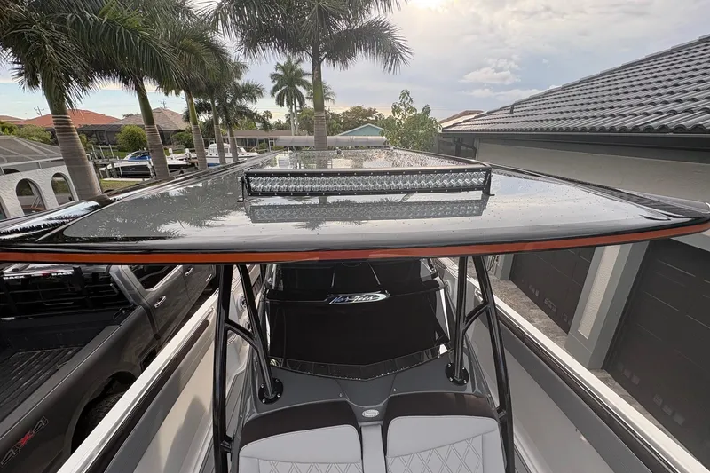 Slide: The Image of 2024 Nor-Tech 390 Sport Center Console boat with sleek T-top and modern design. - 10