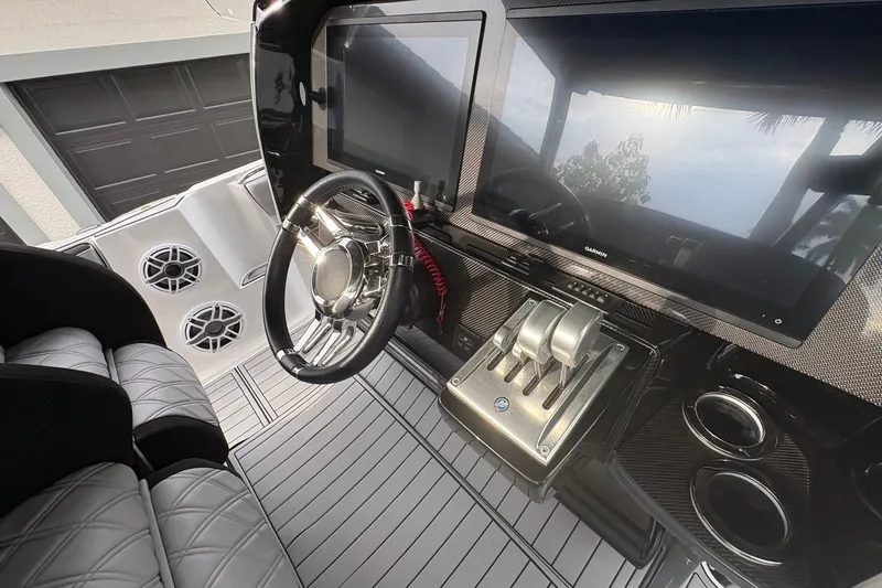Slide: The Image of 2024 Nor-Tech 390 Sport Center Console dashboard with steering wheel and advanced controls. - 11
