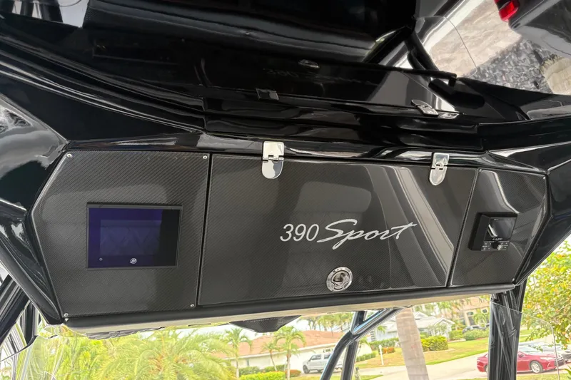 Slide: The Image of 2024 Nor-Tech 390 Sport Center Console dashboard with sleek black design and modern controls. - 14