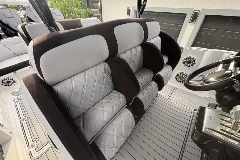 Slide: The Image of 2024 Nor-Tech 390 Sport Center Console interior with plush seating and modern design. - 15