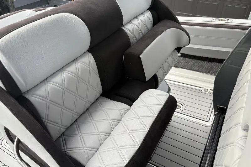Slide: The Image of Luxurious seating on 2024 Nor-Tech 390 Sport Center Console boat, featuring diamond-stitched upholstery. - 18