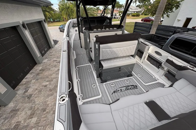 Slide: The Image of 2024 Nor-Tech 390 Sport Center Console boat with luxurious seating and sleek design. - 21