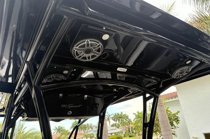 Slide: The Image of 2024 Nor-Tech 390 Sport Center Console with sleek black roof and integrated speakers. - 22