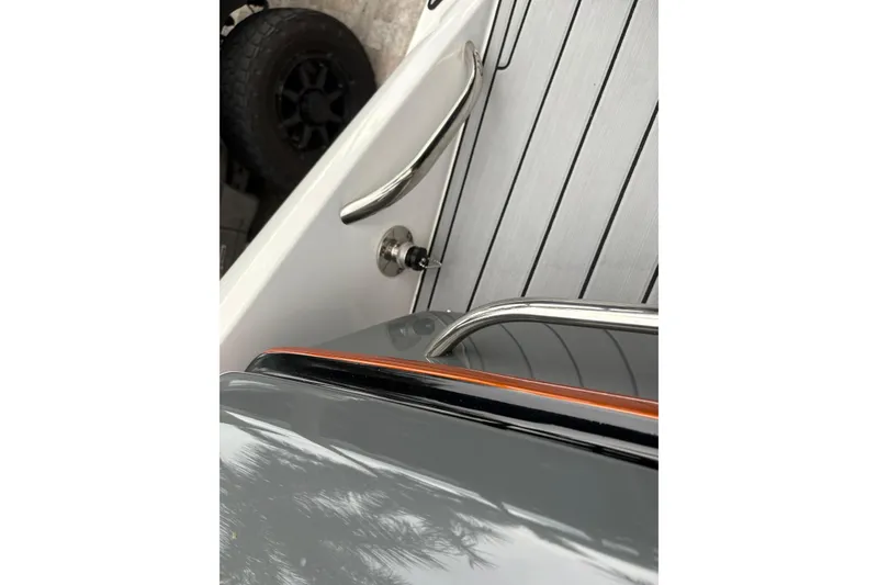 Slide: The Image of 2024 Nor-Tech 390 Sport Center Console, sleek deck design with stainless steel railings. - 24