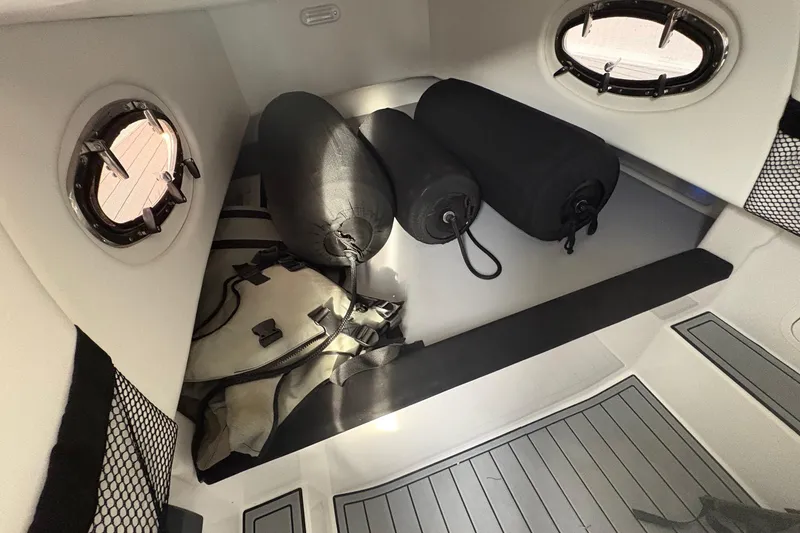 Slide: The Image of Interior storage of 2024 Nor-Tech 390 Sport Center Console with bags and portholes. - 28