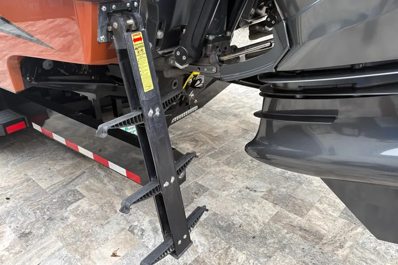 Slide: The Image of 2024 Nor-Tech 390 Sport Center Console boat ladder and engine detail. - 31