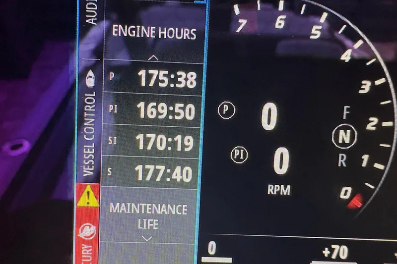 Slide: The Image of Dashboard of 2024 Nor-Tech 390 Sport Center Console showing engine hours and RPM. - 35