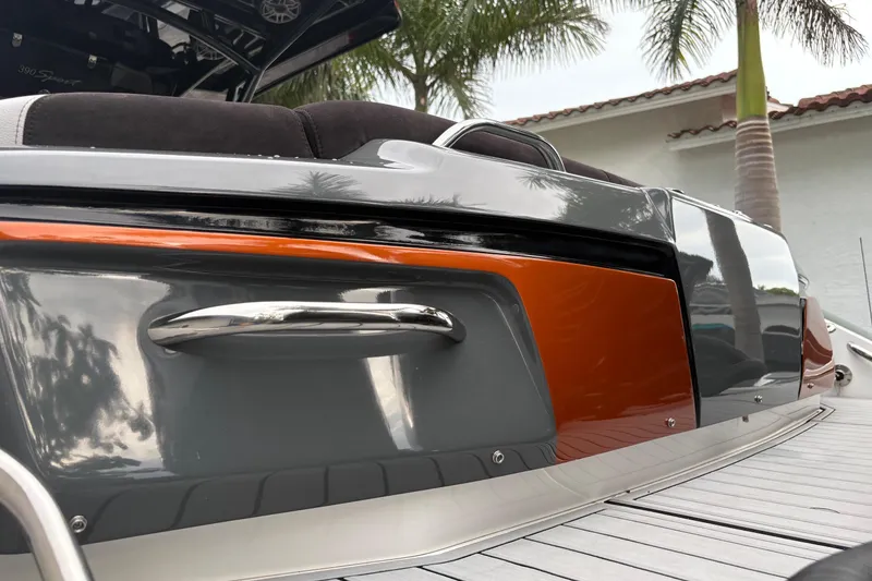 Slide: The Image of 2024 Nor-Tech 390 Sport Center Console boat with sleek design and vibrant orange accents. - 5