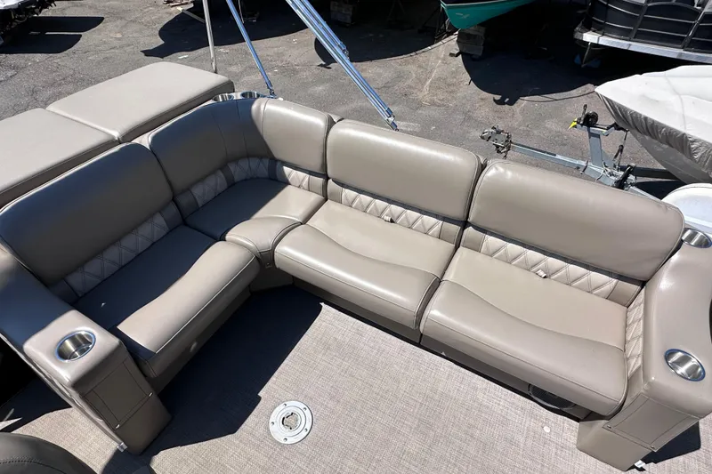 Slide: The Image of 2015 JC 24 Tri-Toon boat with beige leather seating and cup holders. - 10