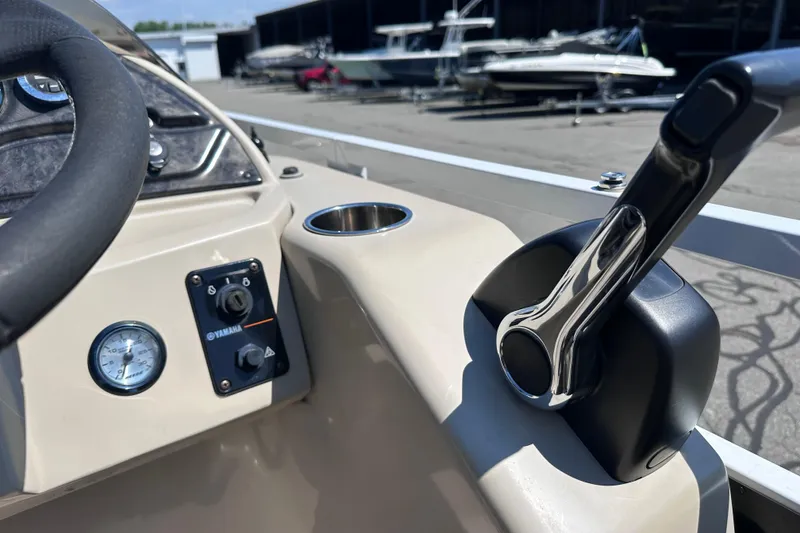 Slide: The Image of Close-up of 2015 JC 24 Tri-Toon boat controls and steering wheel. - 16
