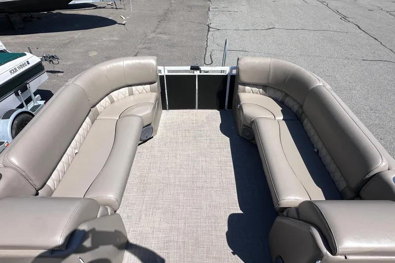 Slide: The Image of 2015 JC 24 Tri-Toon boat interior with beige seating and spacious layout. - 17