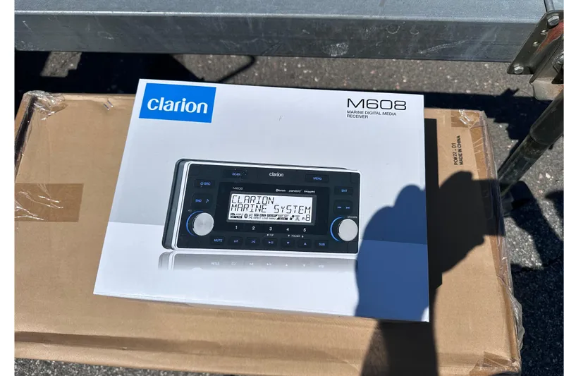 Slide: The Image of Box of Clarion M608 marine digital media receiver on cardboard packaging. - 24