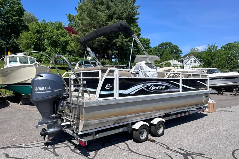Slide: The Image of 2015 JC 24 Tri-Toon pontoon boat with Yamaha outboard motor on trailer. - 3