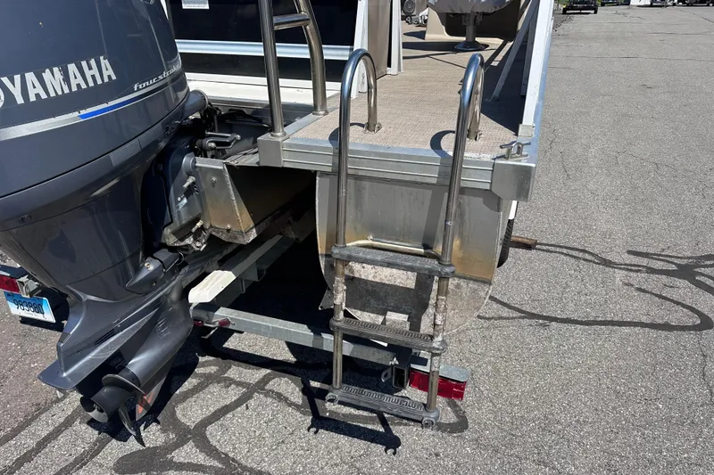Slide: The Image of 2015 JC 24 Tri-Toon boat with Yamaha motor and boarding ladder on trailer. - 5
