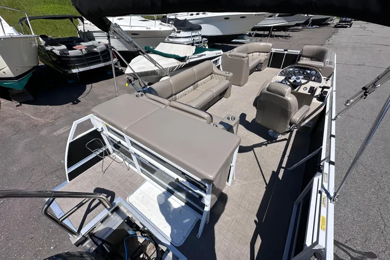 Slide: The Image of 2015 JC 24 Tri-Toon pontoon boat with spacious seating and modern helm controls. - 6