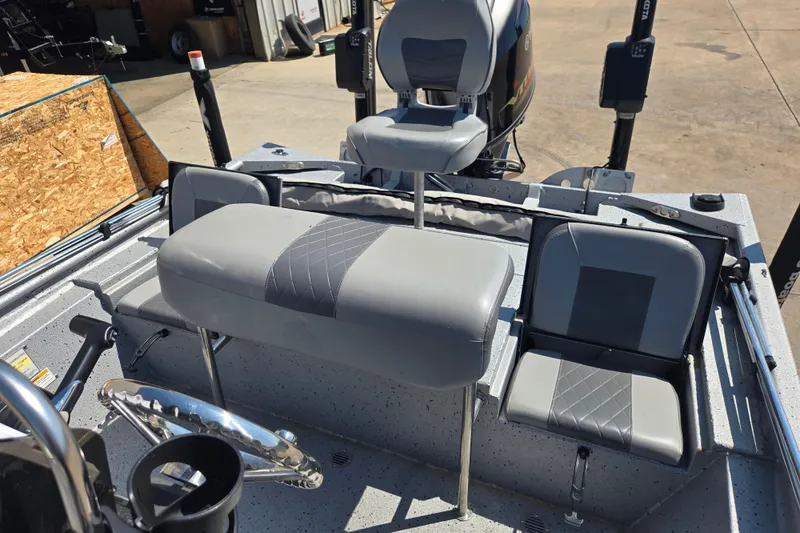 Slide: The Image of 2019 Xpress SW20B boat interior with gray seating and steering wheel. - 11