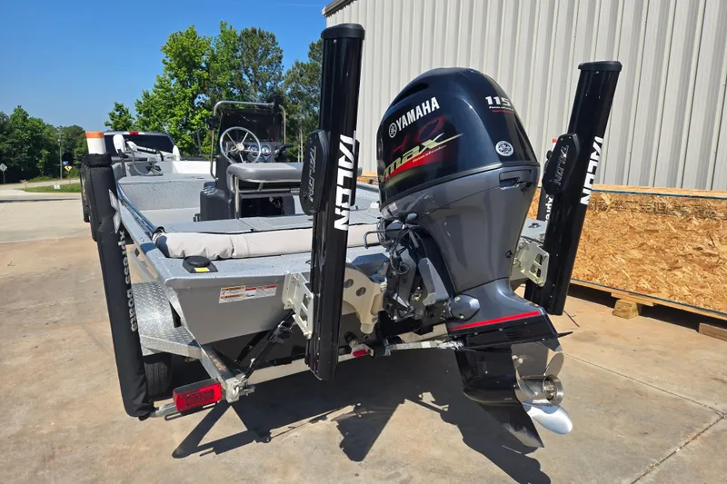 Slide: The Image of 2019 Xpress SW20B boat with Yamaha 115 engine, parked outdoors. - 2