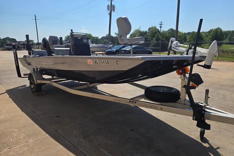 Slide: The Image of 2019 Xpress SW20B boat on trailer, parked outdoors under clear sky. - 5