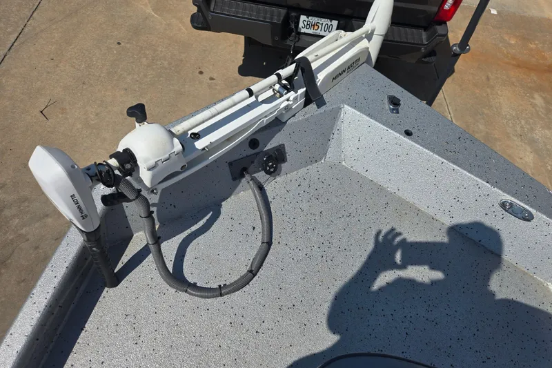 Slide: The Image of 2019 Xpress SW20B boat with Minn Kota trolling motor on concrete surface. - 8