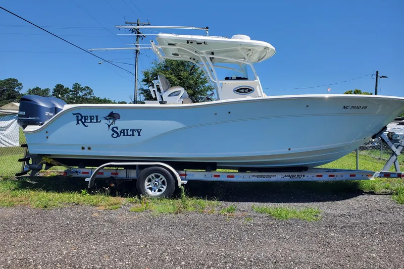 Slide: The Image of 2015 Sea Fox 286 Commander boat on trailer, labeled "Reel Salty," with Yamaha engine. - 12